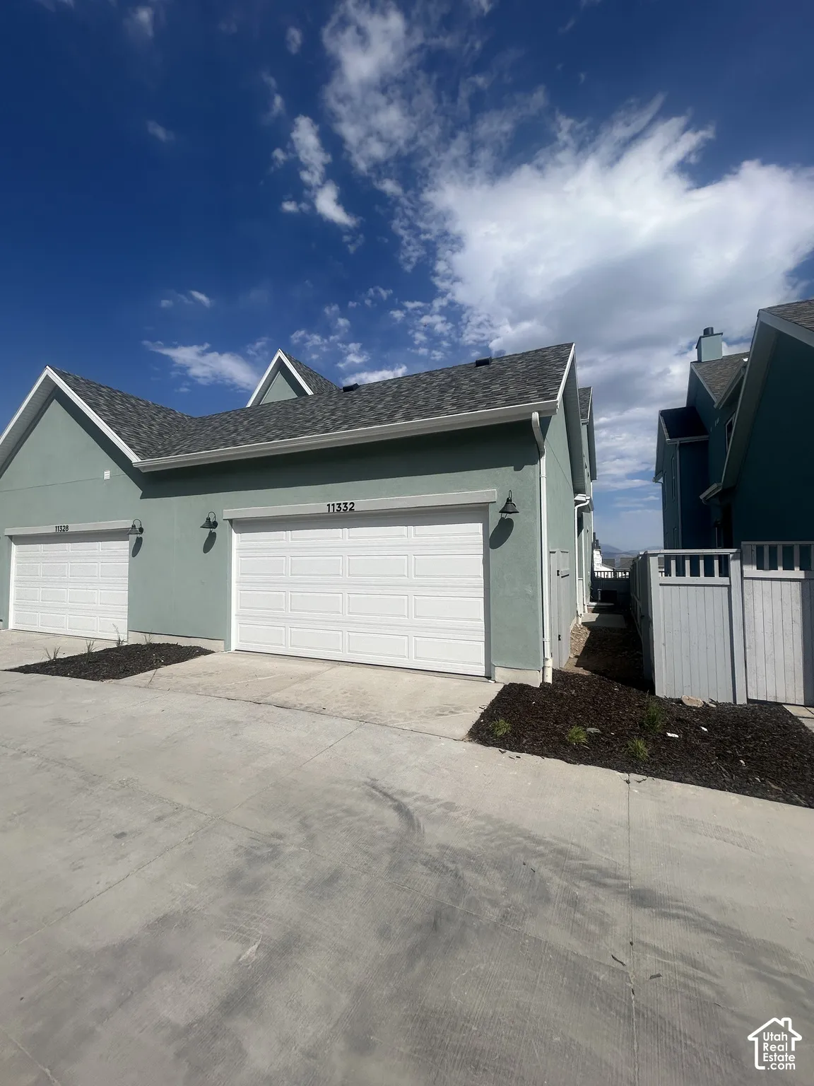 Contemporary stucco exterior with two separate garage bays