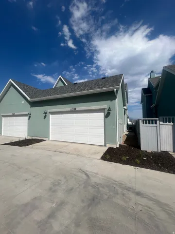 Contemporary stucco exterior with two separate garage bays