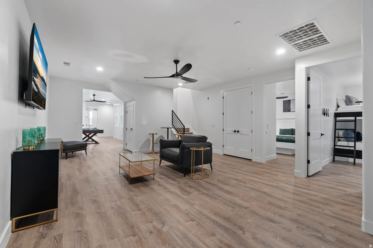 Spacious interior featuring wood-finish flooring, recessed lighting, and a modern ceiling fan