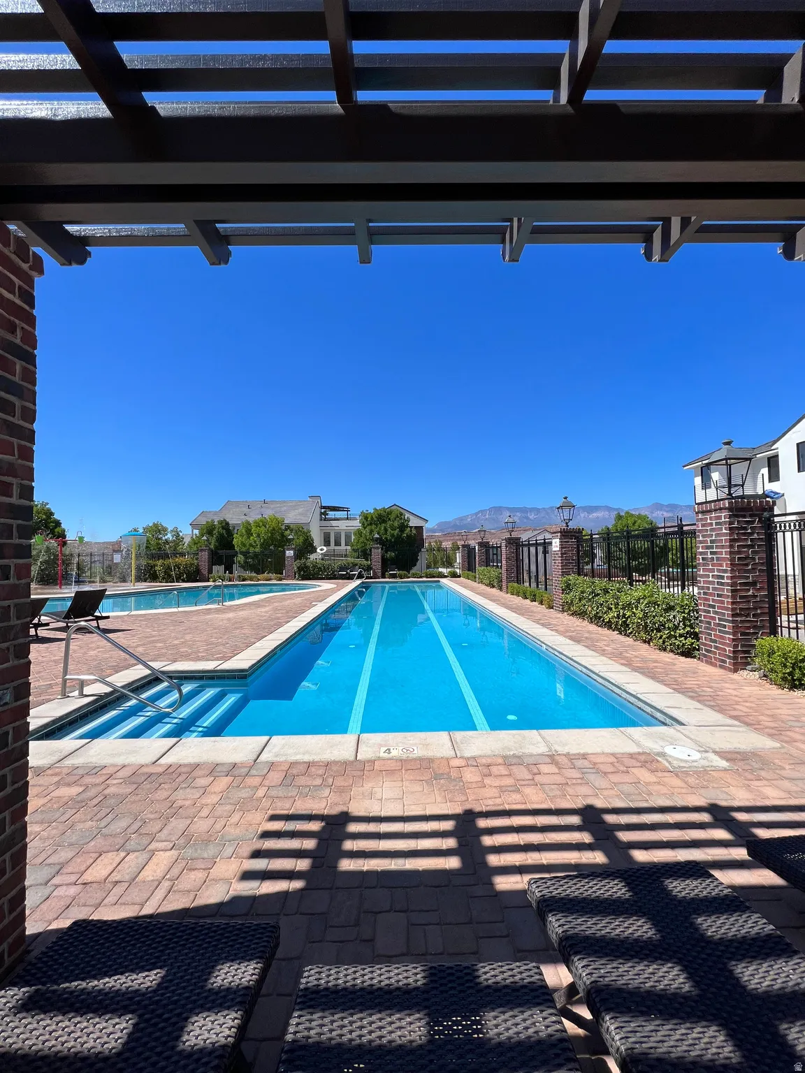 Community swimming pool featuring lap lanes and integrated steps