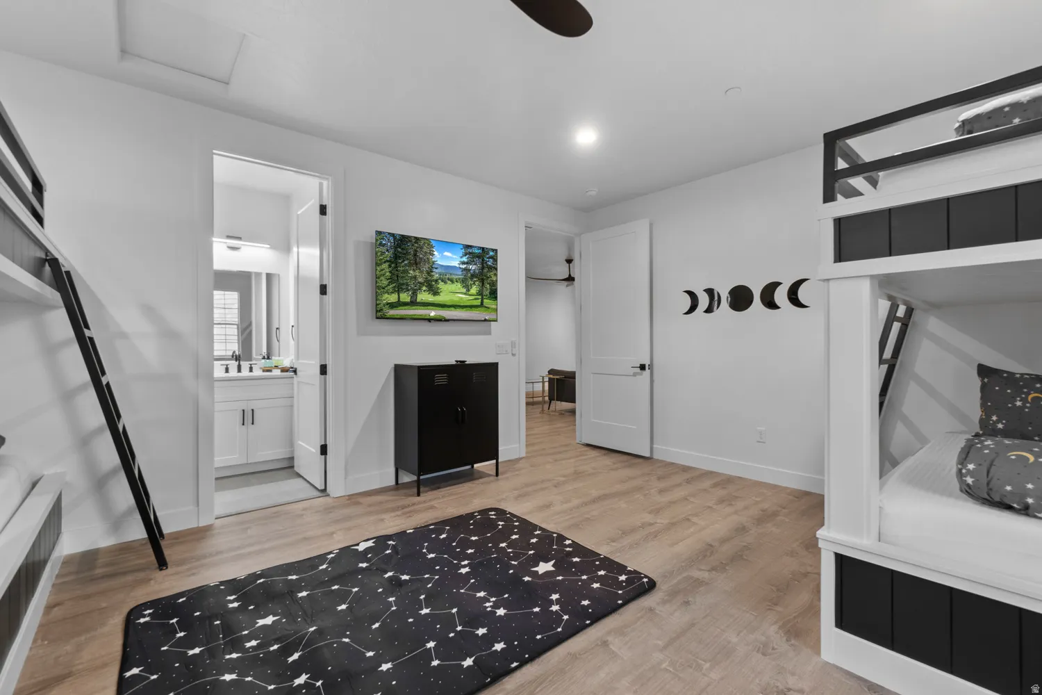 Interior room featuring plank wood-finish flooring and white walls