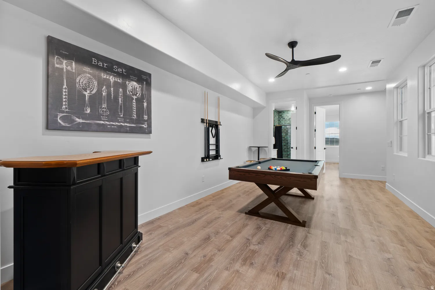 Recreational space featuring wood-finish flooring, recessed lighting, and a modern ceiling fan