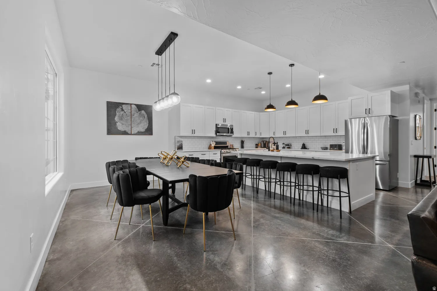 Open-concept living space with concrete flooring