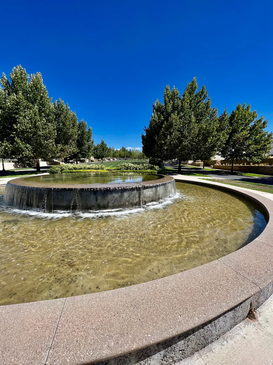 Circular stone-finish water feature with flowing water