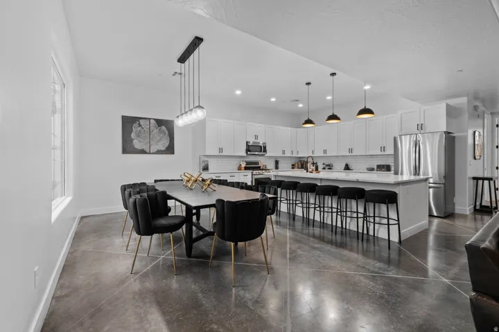 Open-concept living space with concrete flooring
