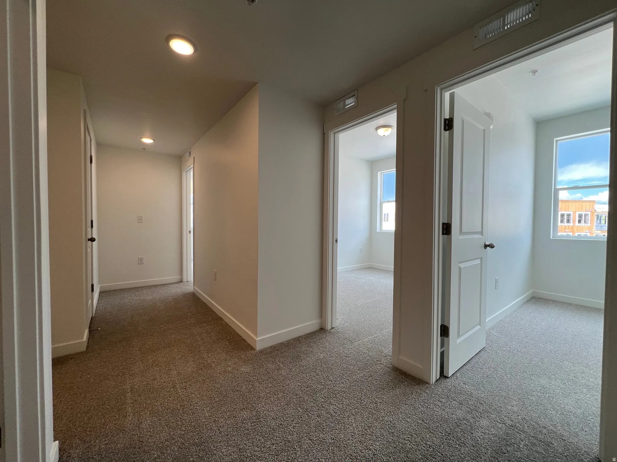 Hallway featuring recessed lighting, neutral paint, and carpet flooring