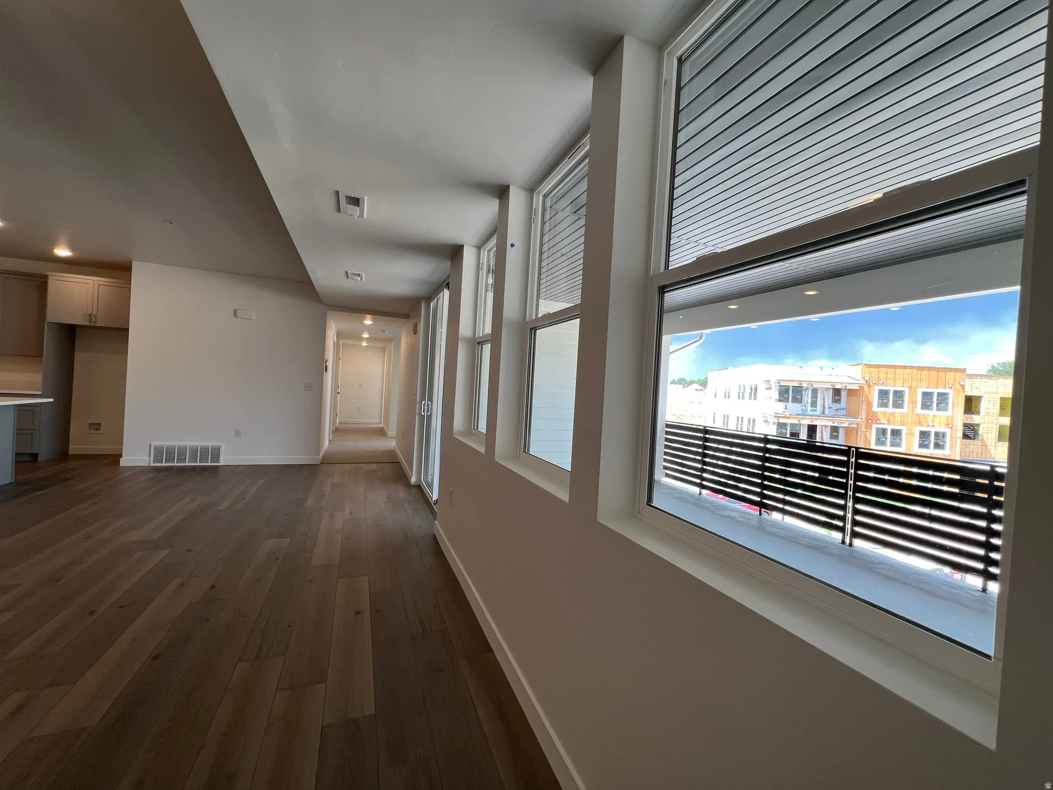 Expansive wood-finish flooring throughout the open concept living area