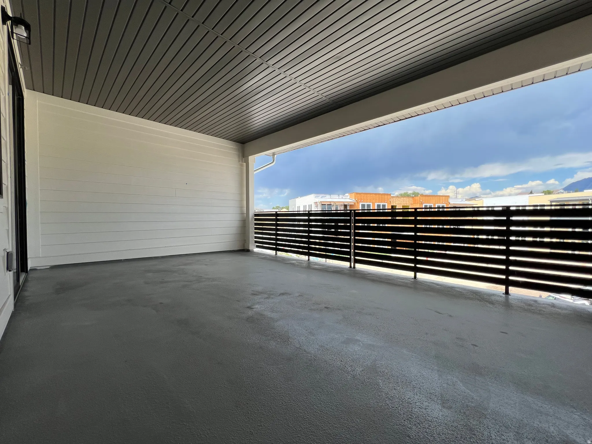 Spacious covered patio with concrete flooring