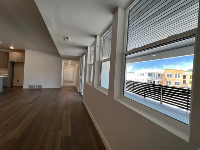 Expansive wood-finish flooring throughout the open concept living area