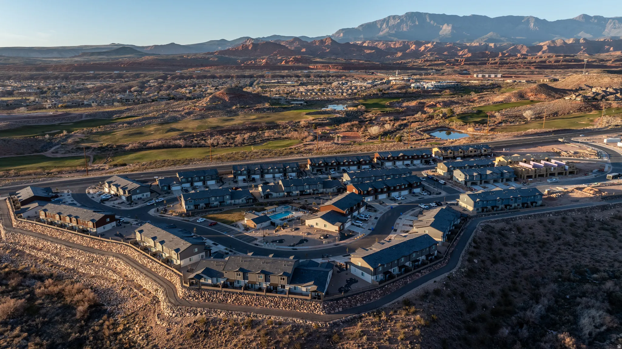 Community featuring multi-level residences, an outdoor pool, and structured road network