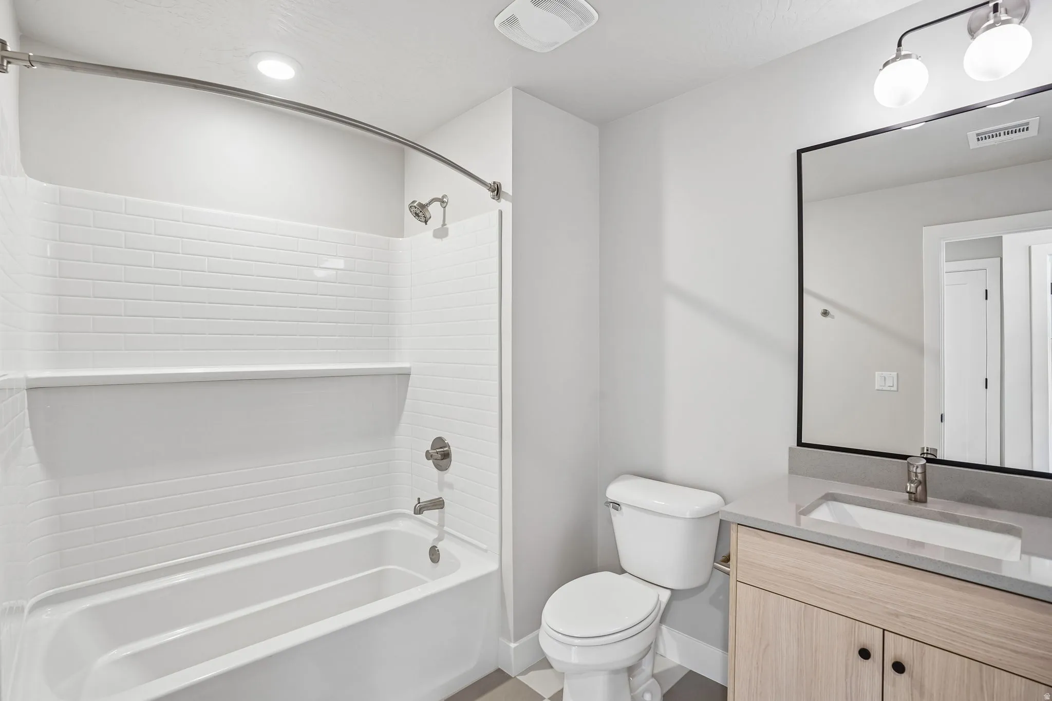 Modern bathroom featuring a wood-finish vanity with dual cabinet storage, a rectangular vessel sink, and a brushed nickel faucet