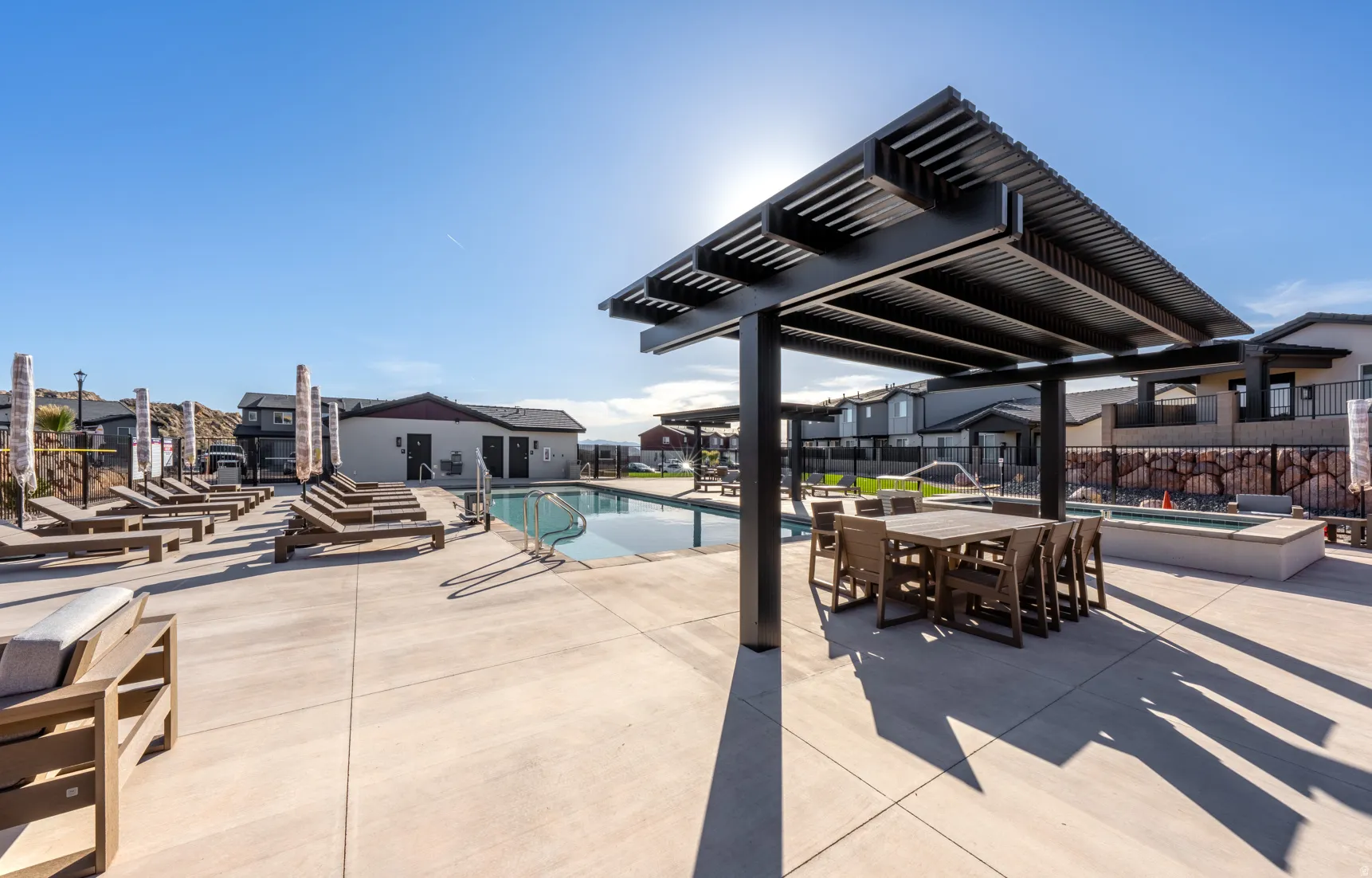 Outdoor swimming pool with integrated spa and concrete surround