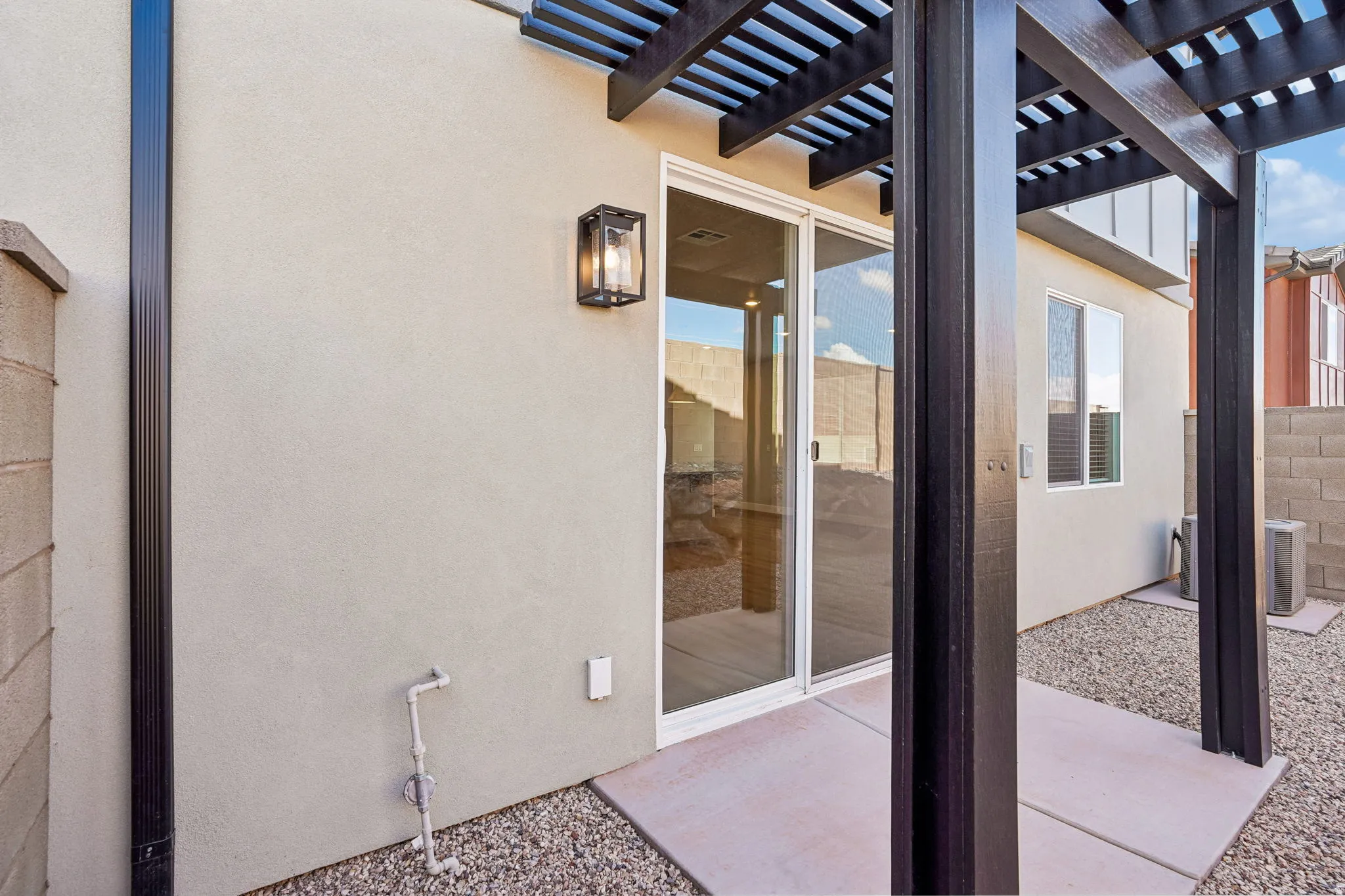 Exterior stucco finish with an attached pergola