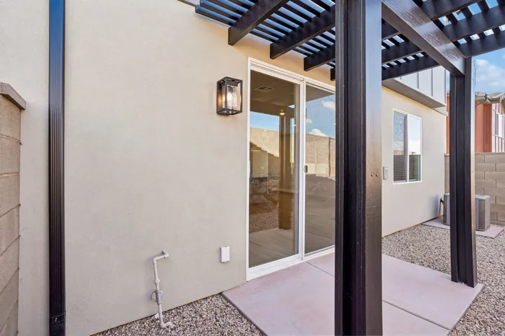 Exterior stucco finish with an attached pergola