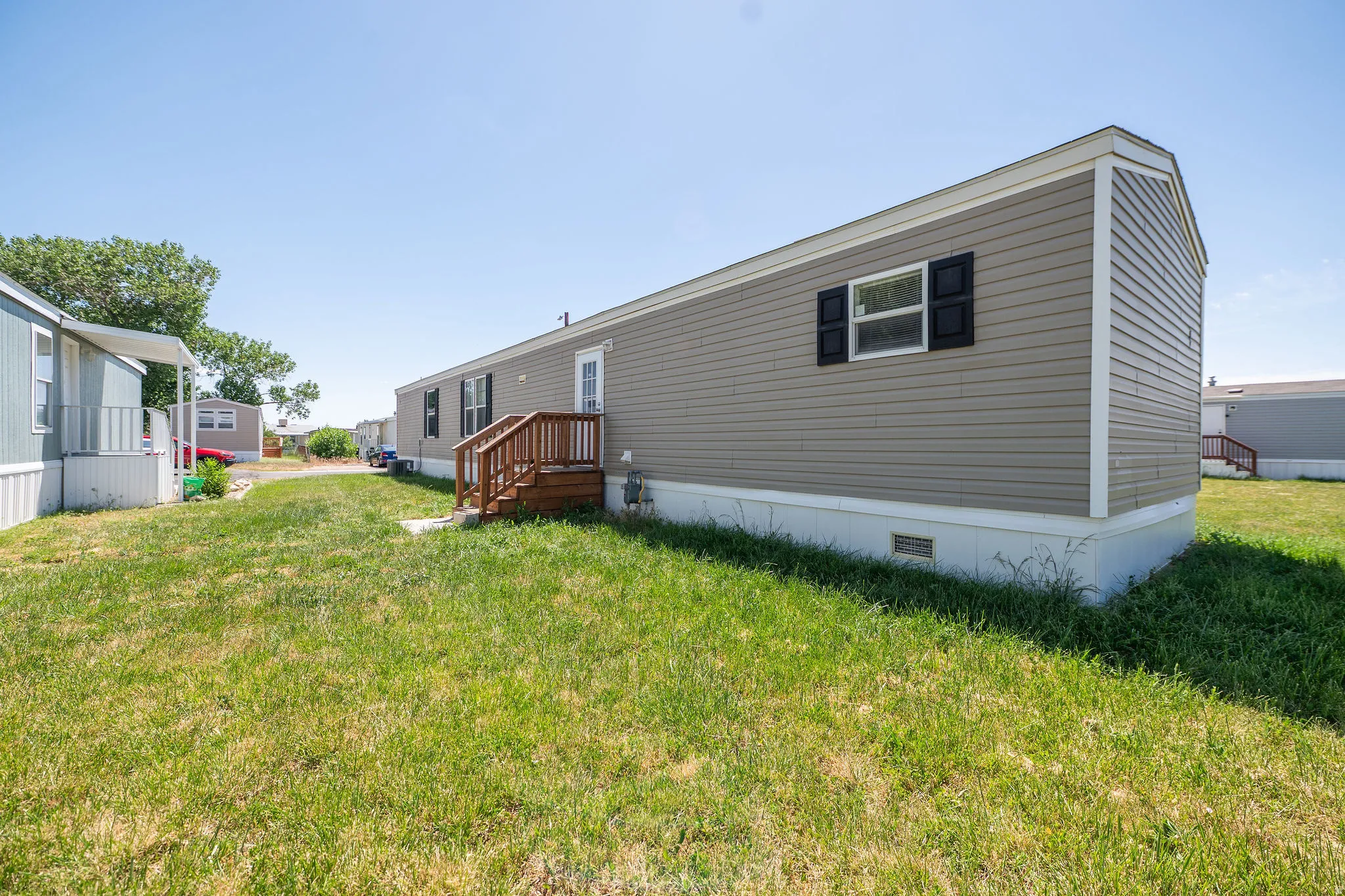 Exterior with horizontal siding, black window shutters, and a white trim