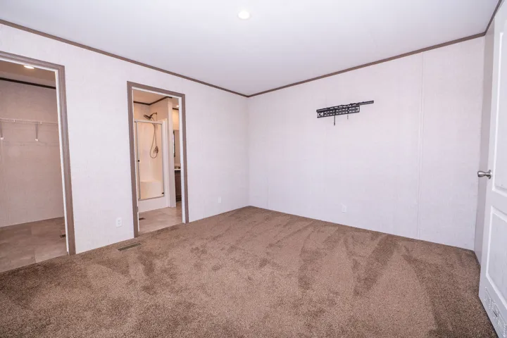Spacious room with plush brown carpeting and white walls