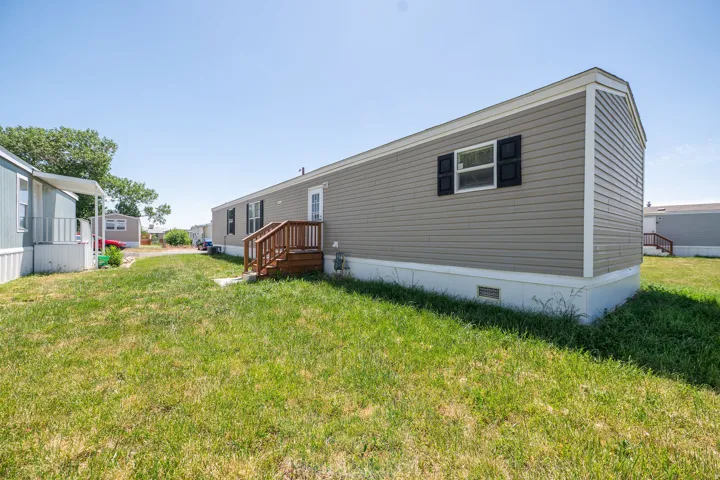 Exterior with horizontal siding, black window shutters, and a white trim