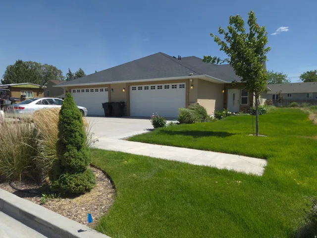 Duplex property featuring a tan exterior with white trim