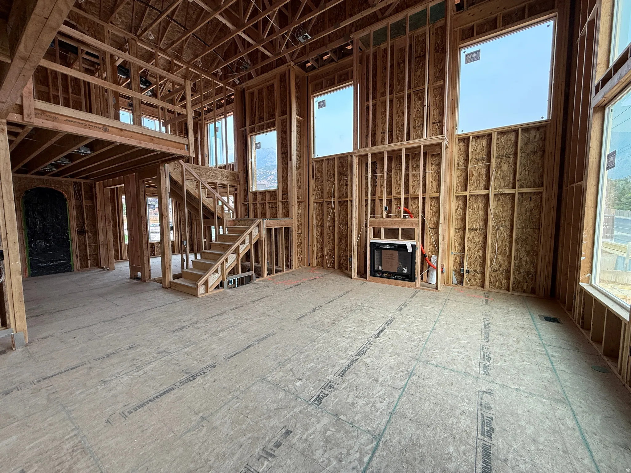 Two-story interior framing with an integrated fireplace unit