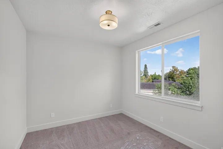 Neutral-toned walls complement the carpeted flooring