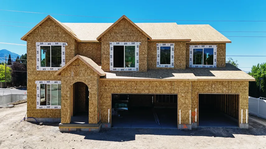 New construction framing featuring multiple gables and a covered entry