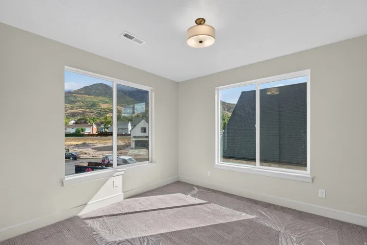 Neutral wall finishes complement the textured carpeting