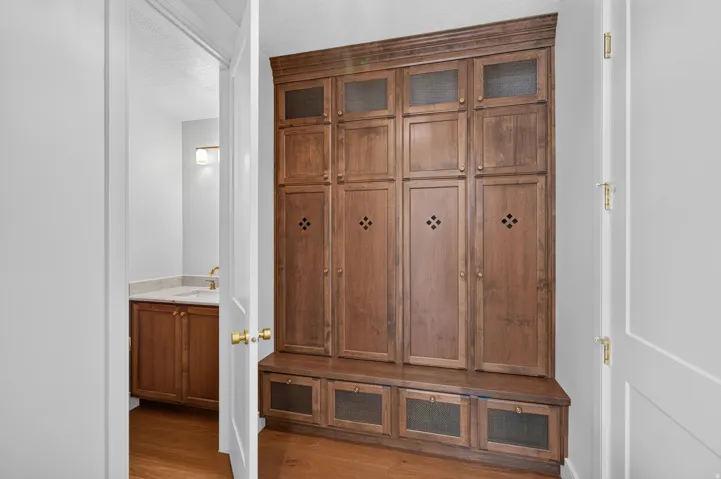 Built-in wood cabinetry with bench seating and multiple storage compartments