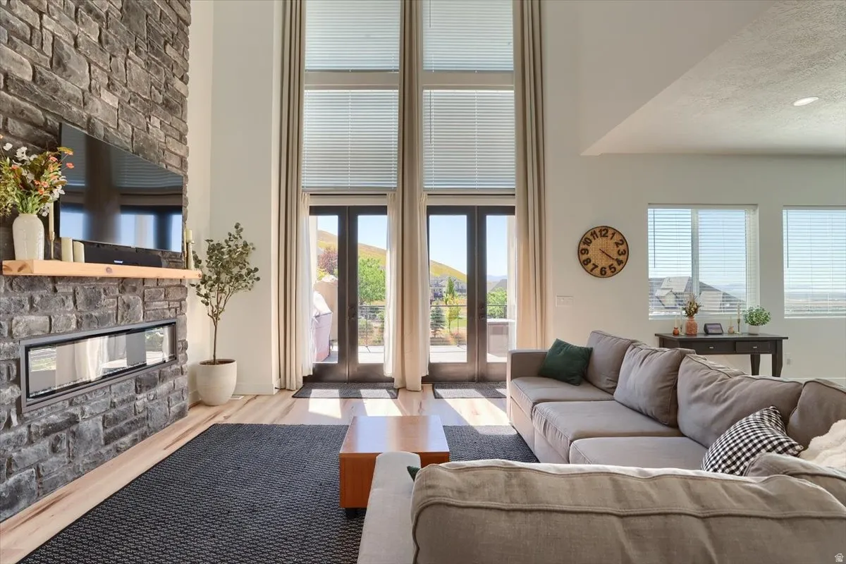 Stone-clad fireplace with an integrated linear firebox and wood mantel shelf