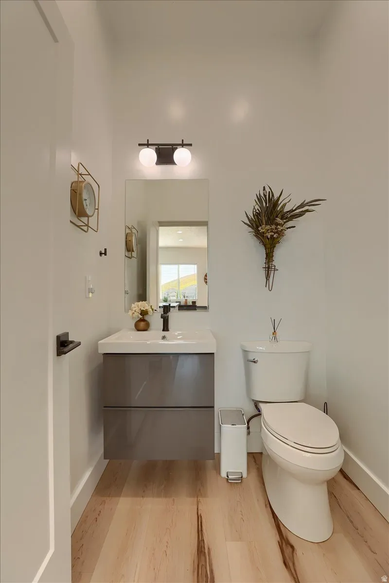 Powder room featuring a floating vanity with a gray finish, integrated sink, and matte black faucet