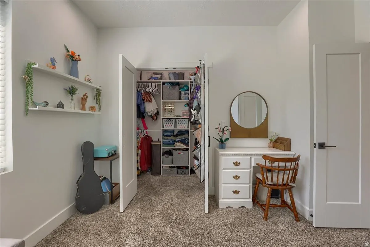 Spacious closet with bi-fold doors and integrated shelving system
