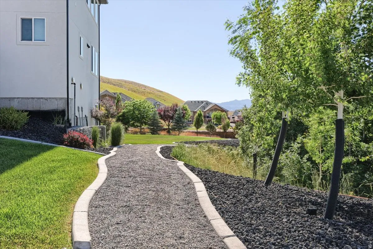 Curved gravel pathway bordered by concrete curbing