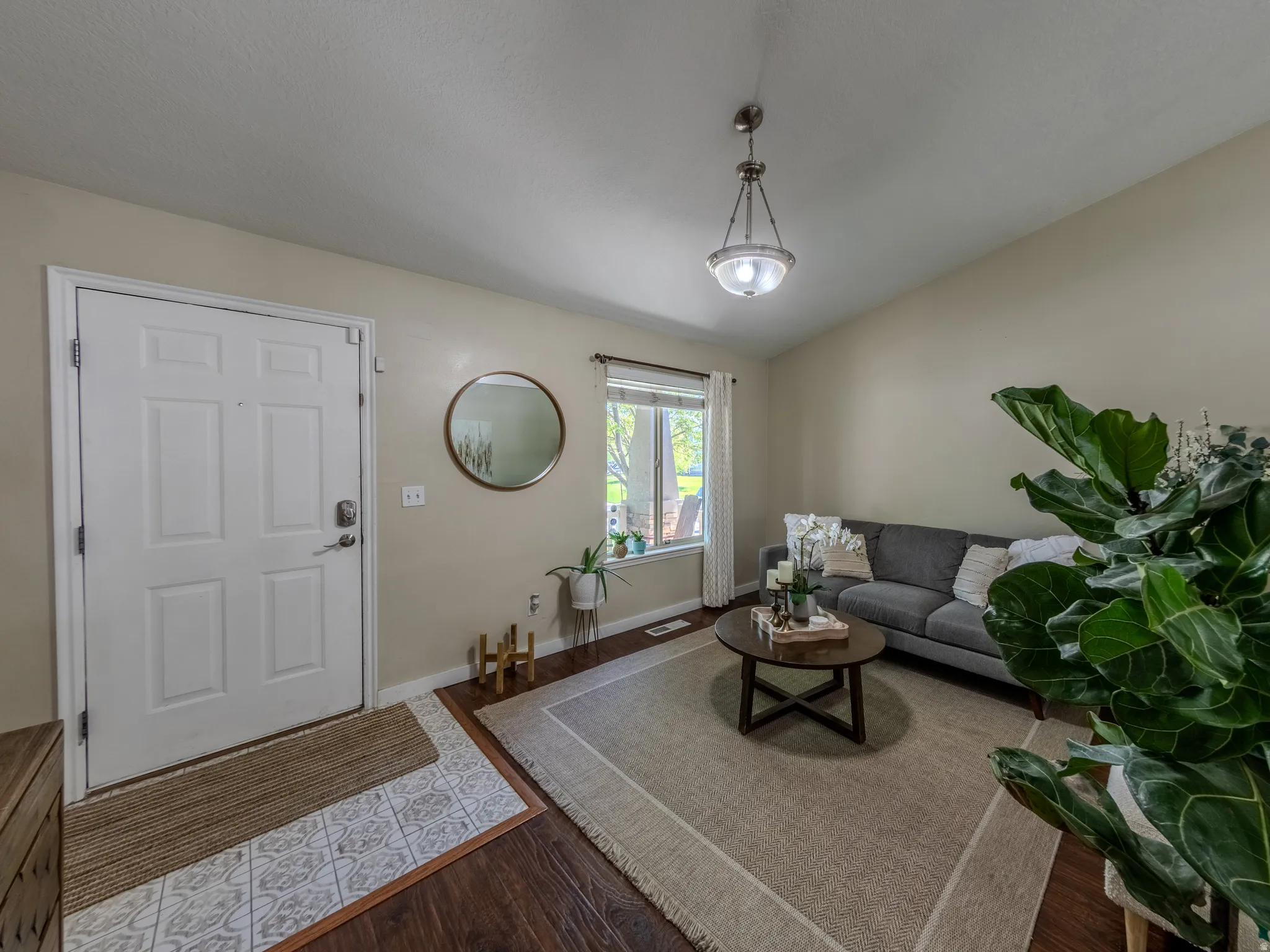 Front entry with a paneled door and decorative floor tile