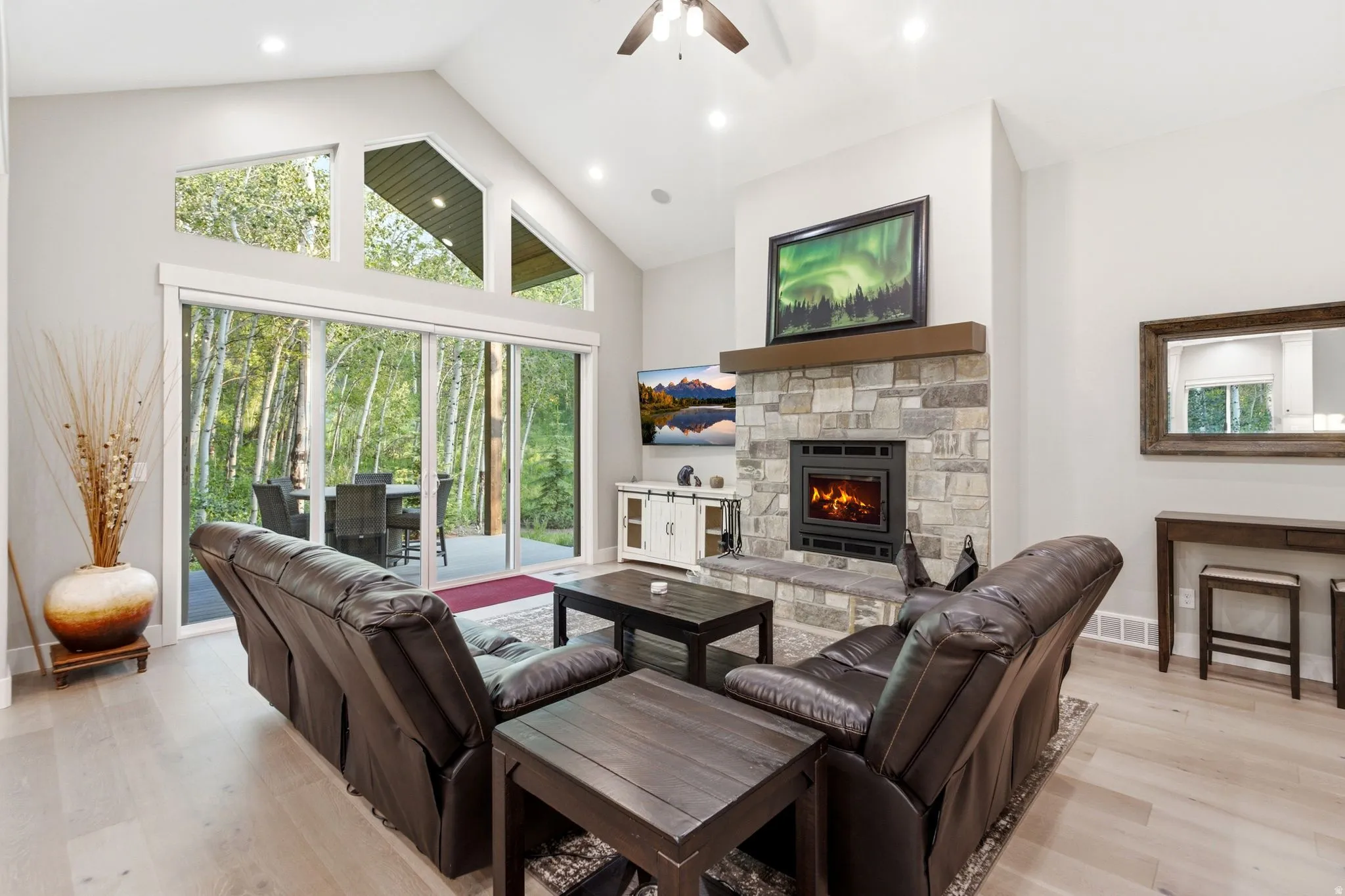 Vaulted ceiling living space with wood-finish flooring