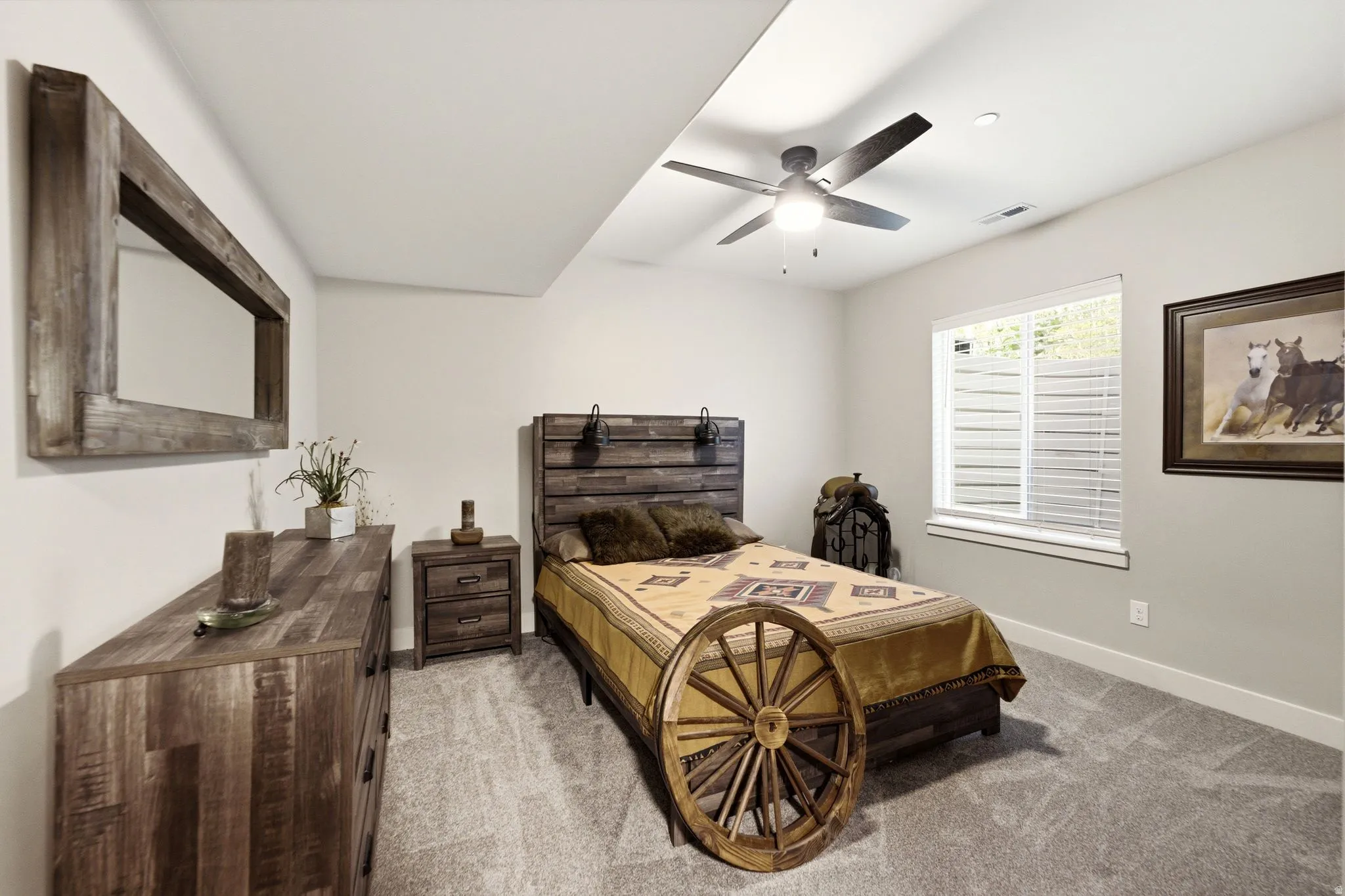 Spacious room featuring neutral paint, soft grey carpet, a window with horizontal blinds, and a ceiling fan with integrated lighting