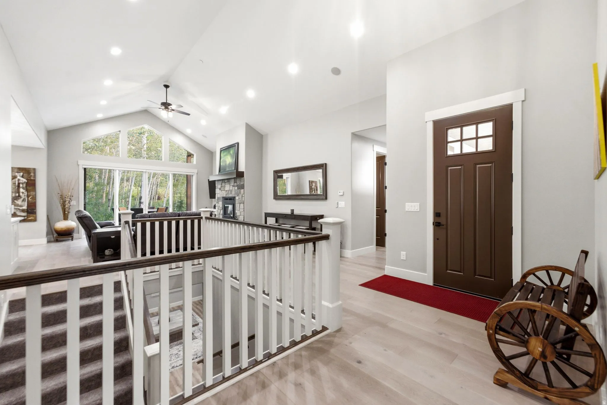 Vaulted ceilings with recessed lighting and a ceiling fan