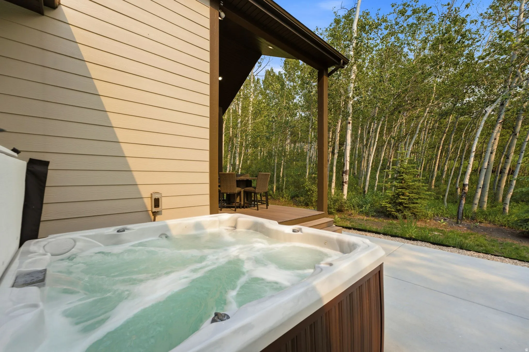 Outdoor spa with bubbling water, set on a concrete patio