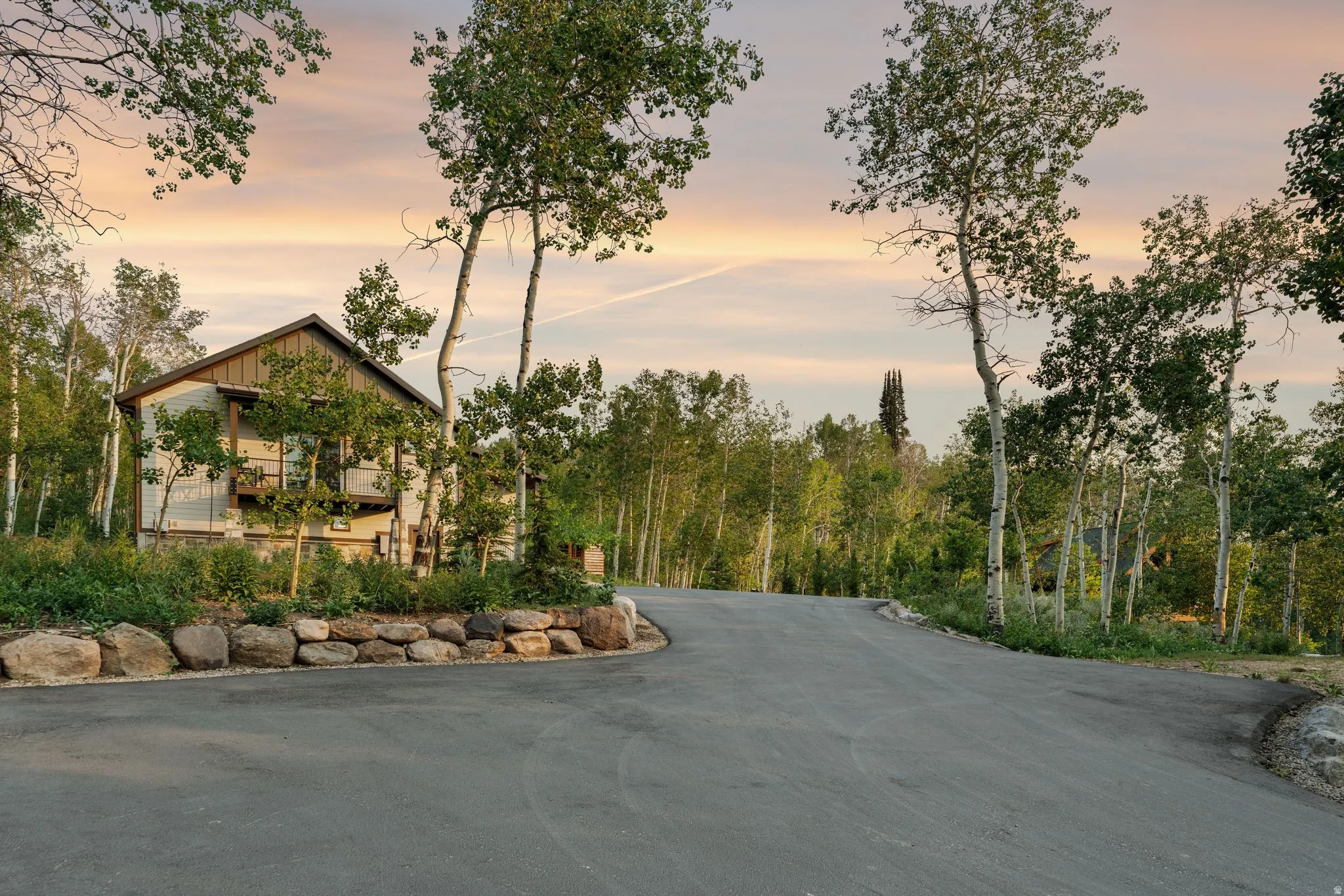Wood-sided residence with an A-frame roofline and exposed beams