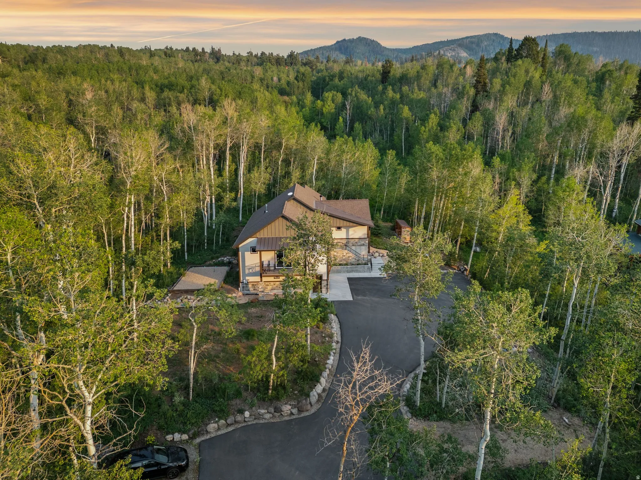 Mountain-style residence surrounded by a dense forest of mature trees