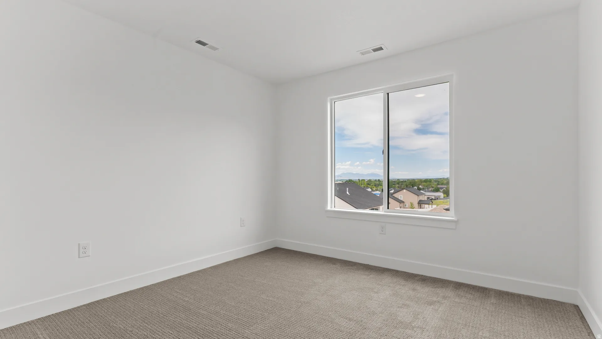 Neutral-toned carpeting complements bright white walls and trim
