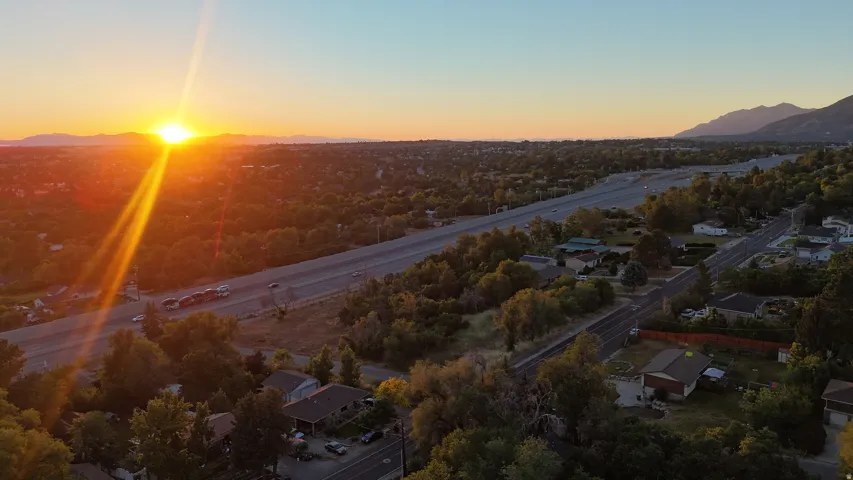 Aerial perspective showcasing a residential area with extensive tree coverage