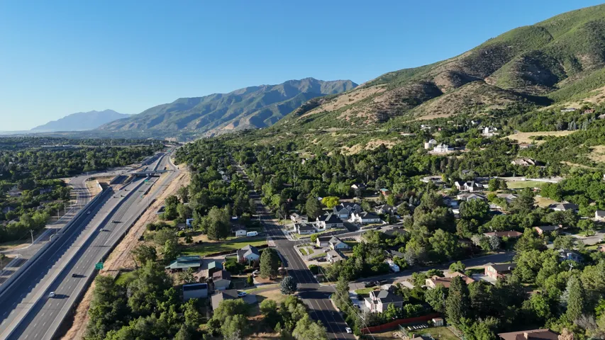 Mountainous terrain and lush green landscape frame the surrounding residential area