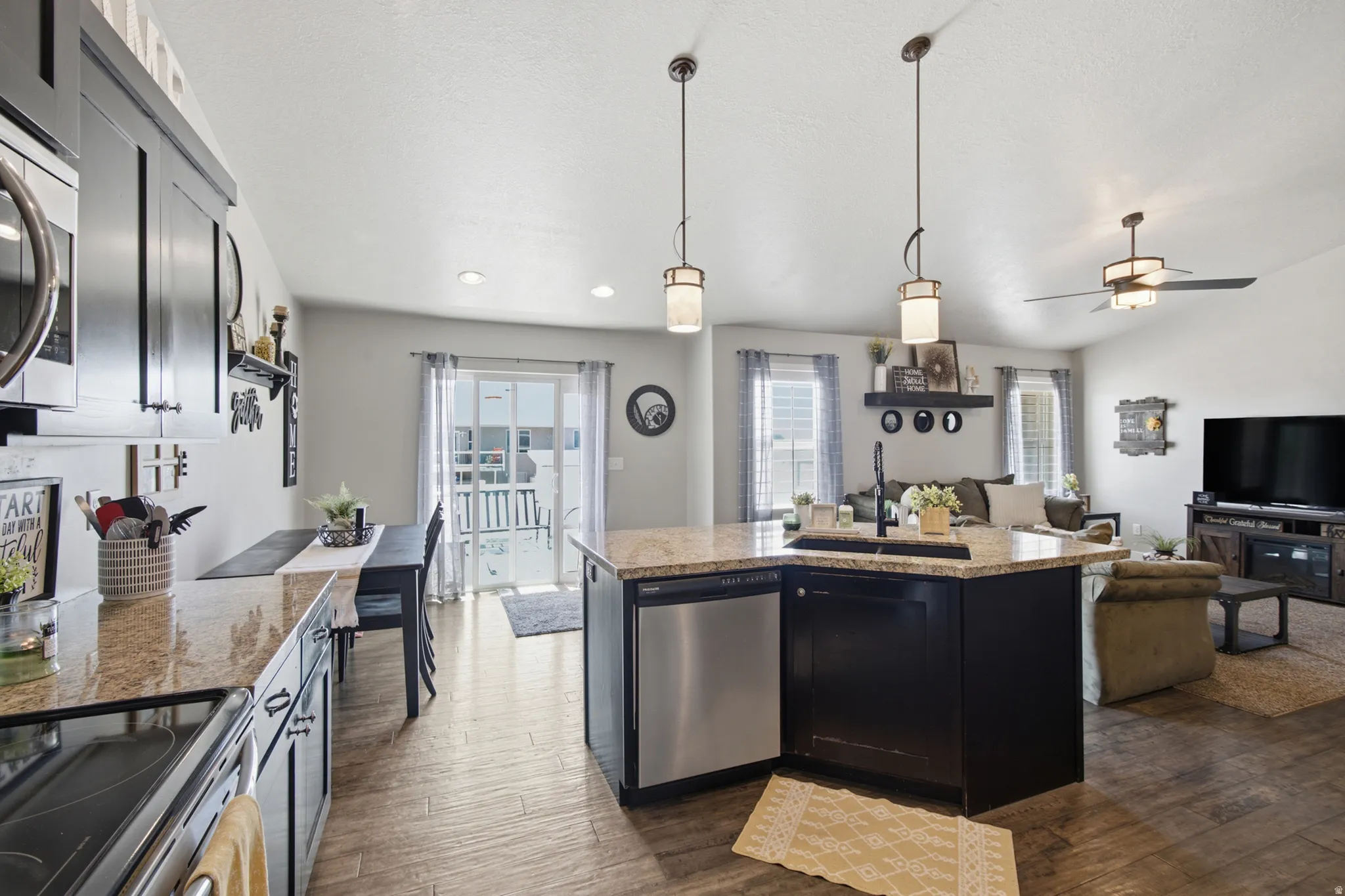 Open-concept living area with wood-finish flooring