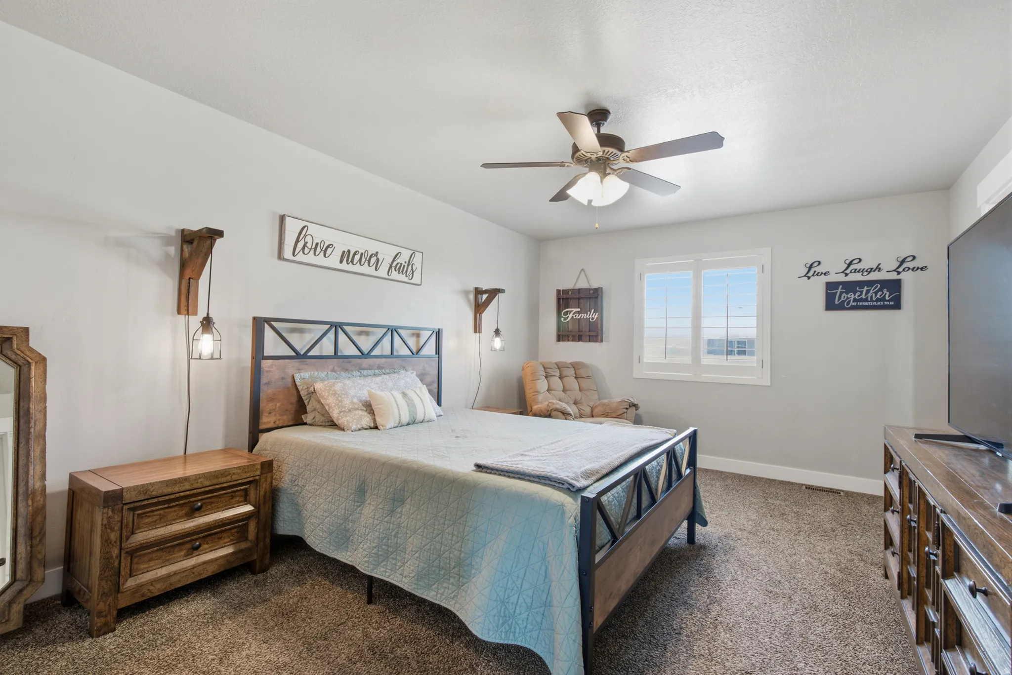Carpeted room with a ceiling fan, a window, and light gray wall paint