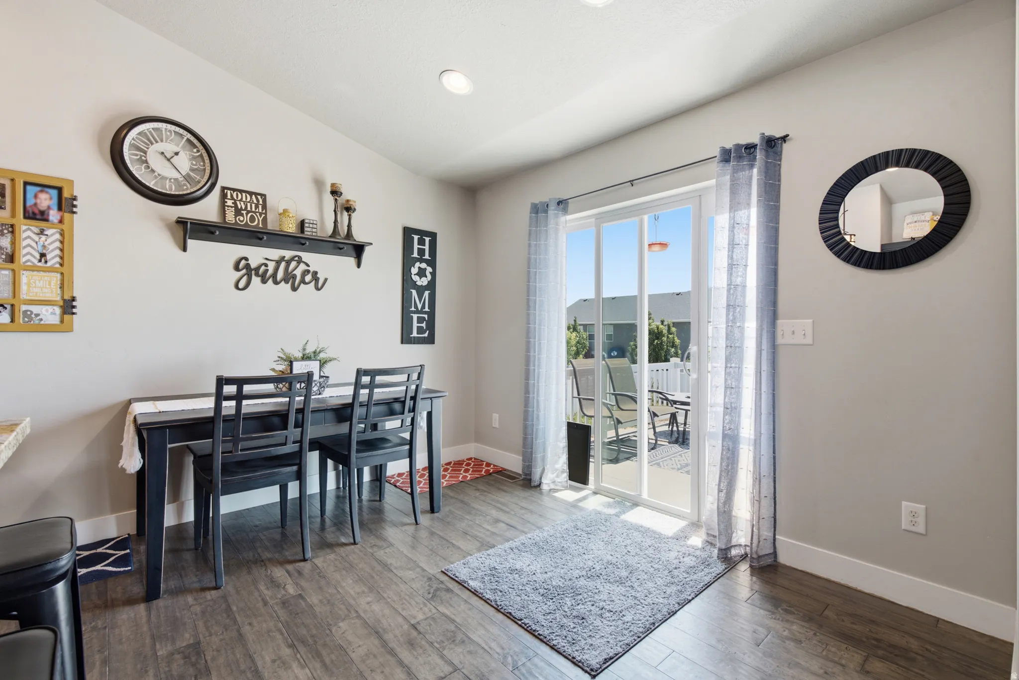 Dining area featuring wood-finish flooring, recessed lighting, and a sliding glass door providing access to an outdoor patio space