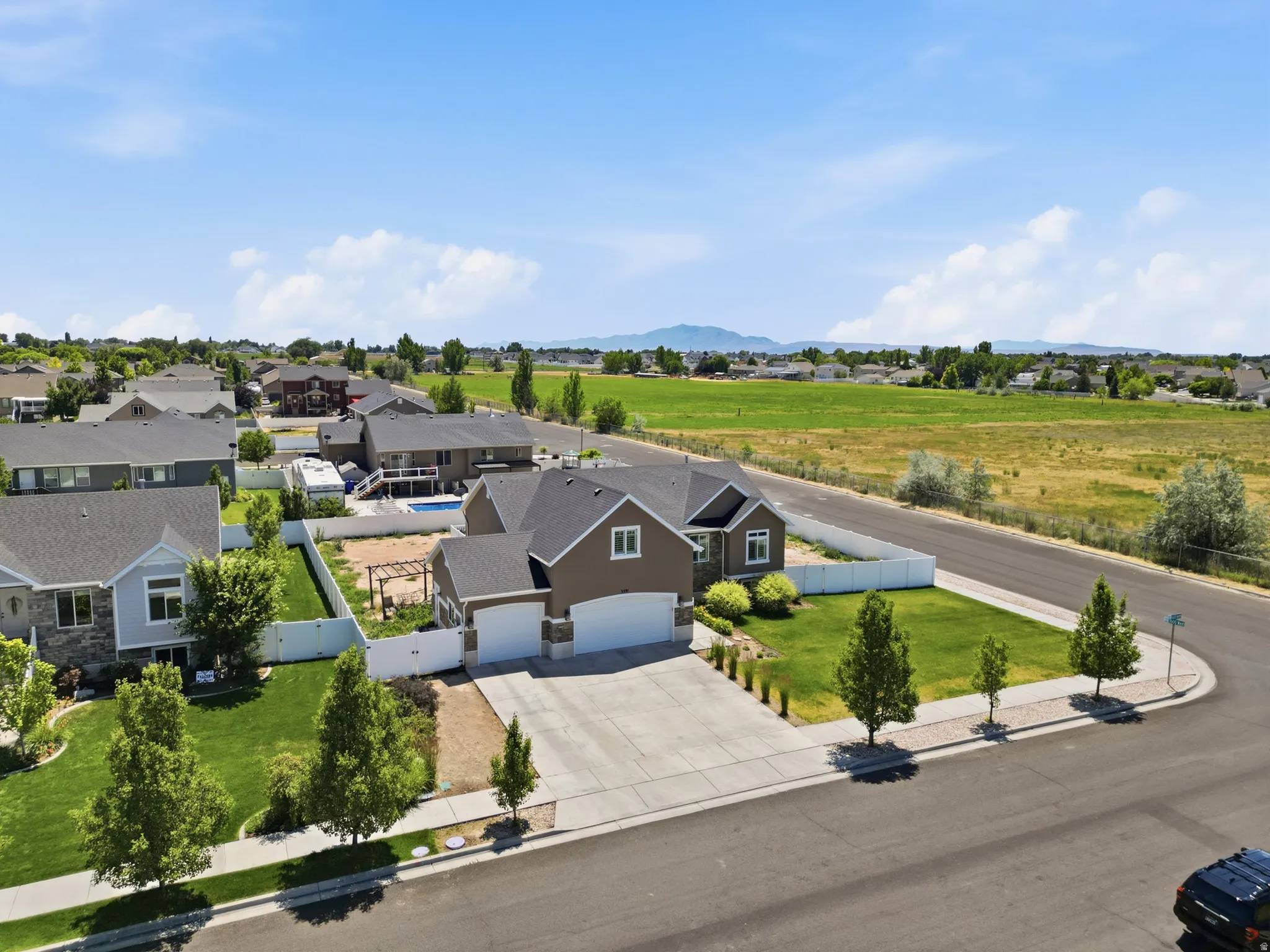 Contemporary residence featuring a two-car garage, concrete driveway, and neatly maintained front lawn