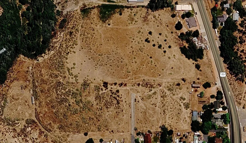Expansive undeveloped land featuring natural vegetation and direct access to a main road