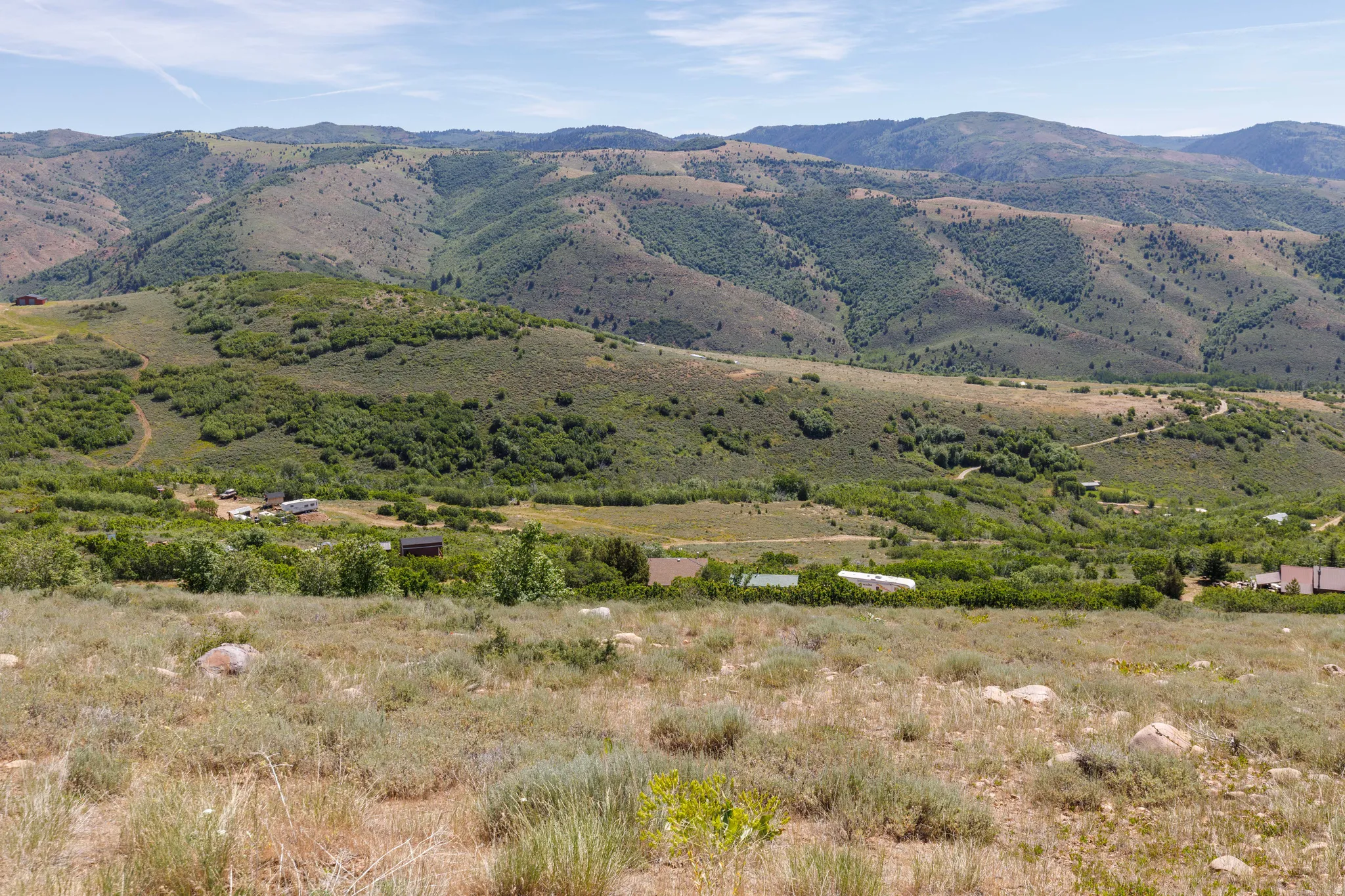 Expansive mountain landscape featuring varied topography with distant hillsides
