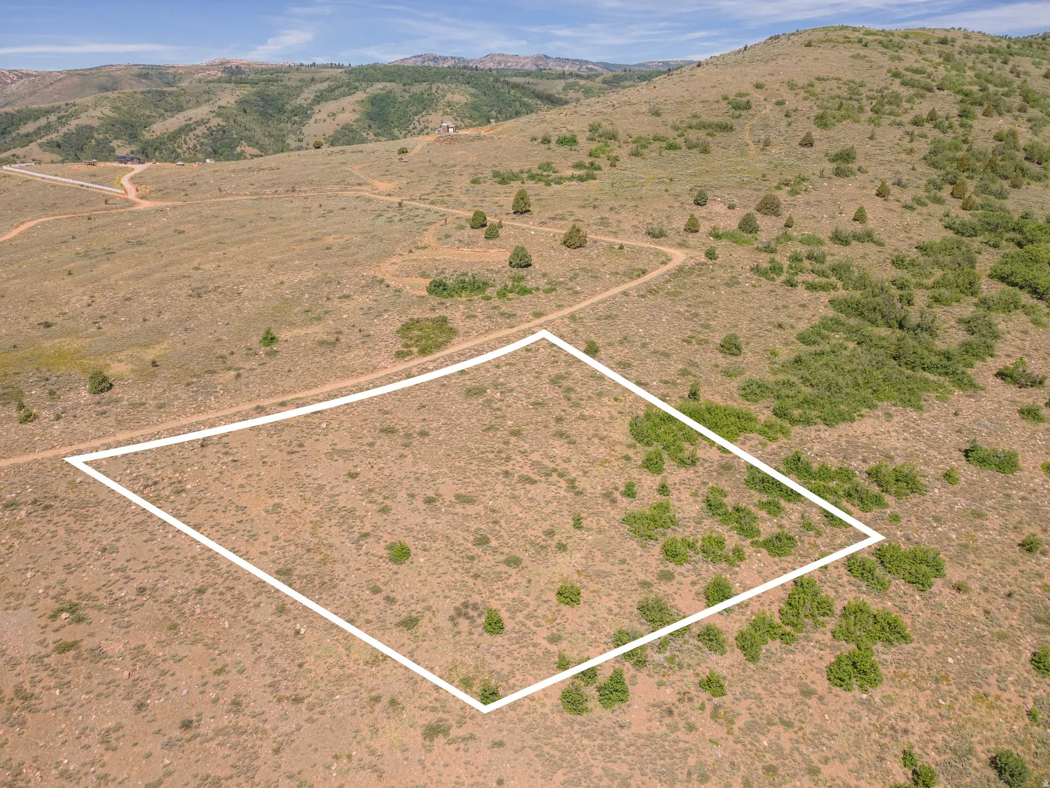 Expansive undeveloped lot featuring natural vegetation and rolling terrain
