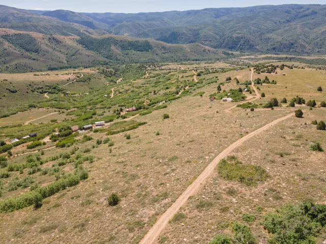 Expansive rural landscape featuring rolling hills and distant mountains