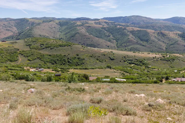 Expansive mountain landscape featuring varied topography with distant hillsides